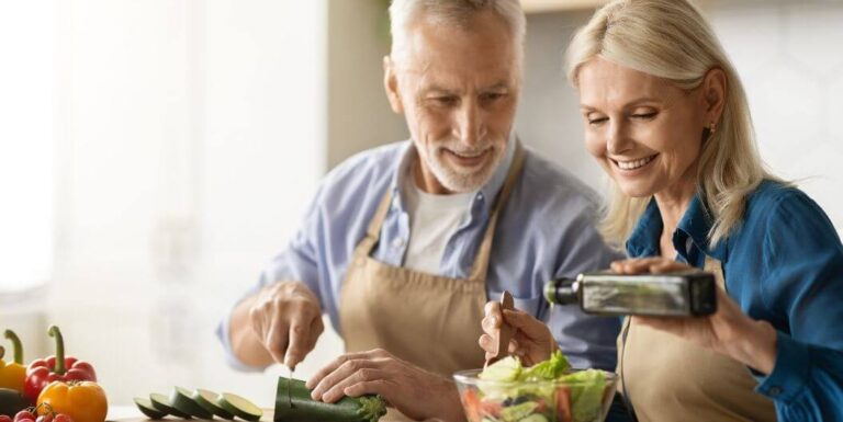 Elderly Couple Preparing Healthy Salad at Assisted Living Facility