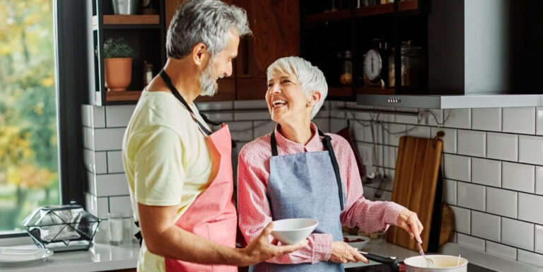 Elderly Couple Cooking Together in a Kitchen at an Assisted Living Facility