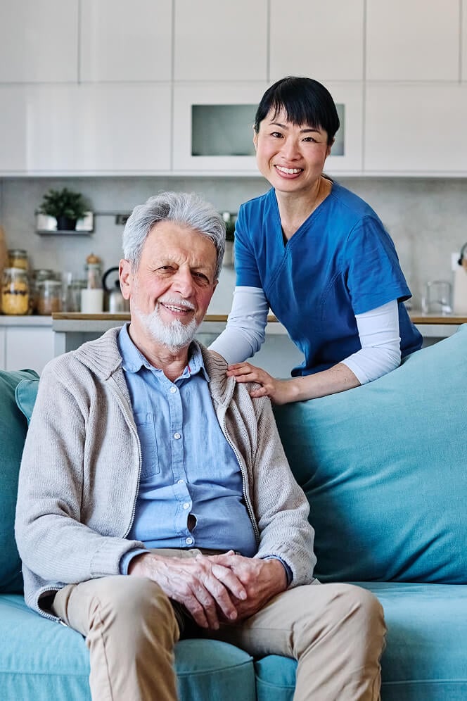 Nurse Comforting Elderly Woman at Nursing Home Oxford